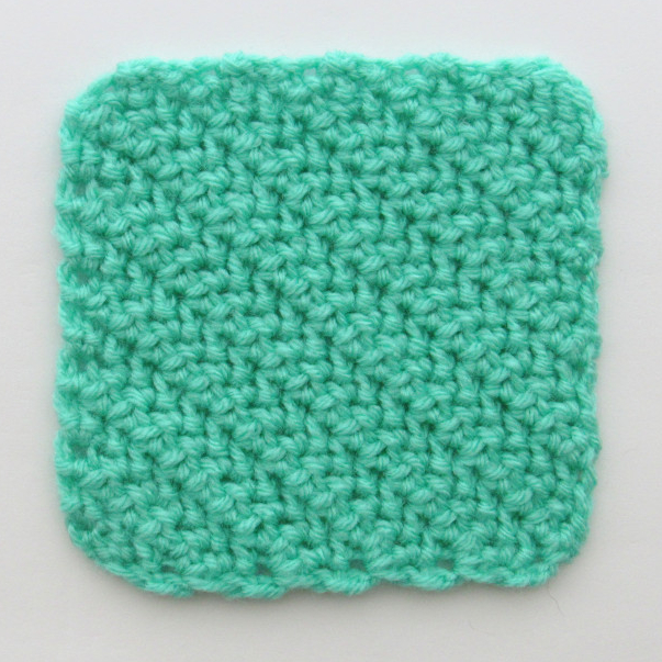 a photo of a green C2C herringbone hdc crochet square