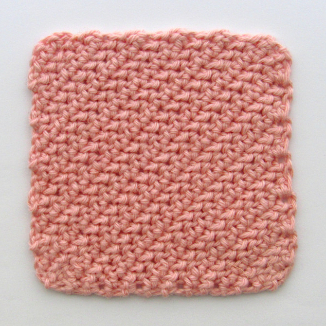 a photo of a pink C2C herringbone hdc crochet square