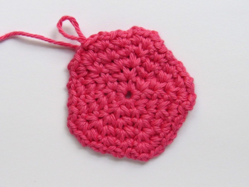 A pink spider crochet circle